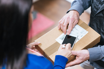 Woman receiving package from delivery man