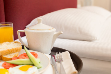 Breakfast in bed in hotel room