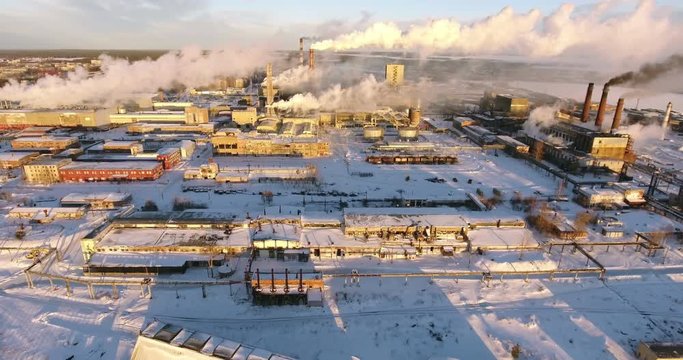 Aerial view at the area of Pulp and Paper mill in Segezha town with smoking chimneys at winter season. Republic of Karelia, Russia