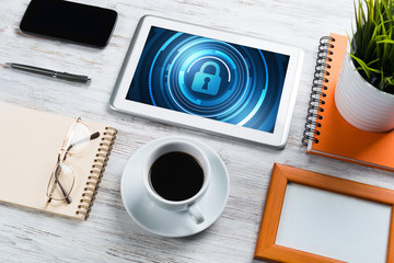 Web security and technology concept with tablet pc on wooden table