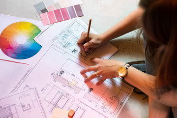 Interior designer draws a plan with art tools