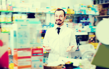 Handsome man pharmacist showing assortment