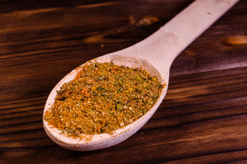 Mix of different seasonings in wooden spoon