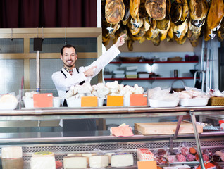 Seller offering displayed sorts of meat
