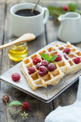 Delicious breakfast with waffles and raspberries