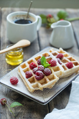 Delicious breakfast with waffles and raspberries