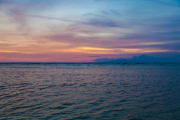 Obraz premium Beautiful sunset over the sea and volcano Agung silhouette on the island of Gili Trawangan, Indonesia