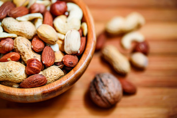 Assorted nuts in wooden bowl