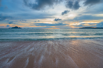 a sandy beach, the sea at sunset, a beautiful sunset on the Andaman Sea in Thailand