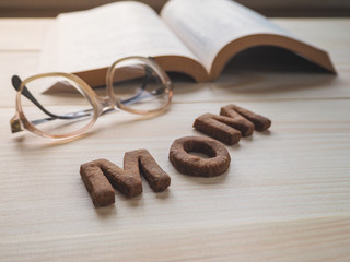 Word Mom biscuit over the wood background. The concept of a single parent.
