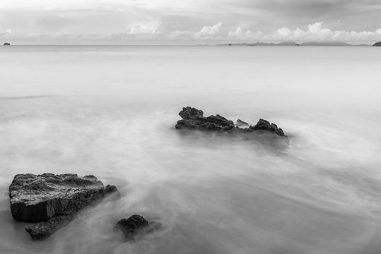 Fototapeta black and white photography stones on the beach washed by the sea waves