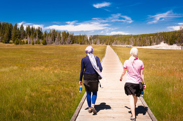 Two women walking through the Yellowstone national park