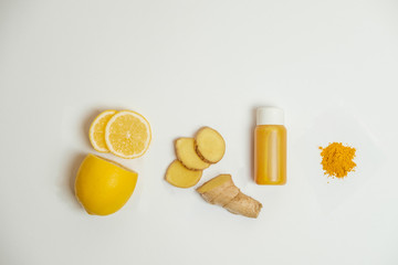 Ginger shot healthy drink with curd in a plastic bottle on white background. Immunity Boosting Tonic. Space for text