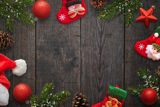 Christmas decorations on dark wooden table. Free space in the middle for text. Top view.
