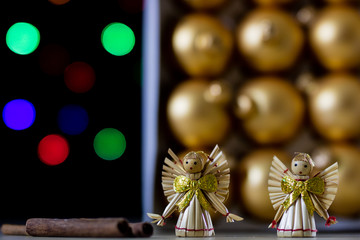 Christmas baubles in a box against a background of Christmas lights. Christmas dinner wrapped in cardboard box on the background of the lamps.