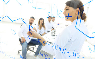 view through the transparent Board. female biochemist analyzing information.