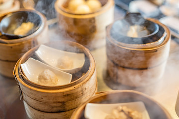 Obraz na płótnie Canvas Dim Sum cooking in steam, kitchen background. Restaurant background