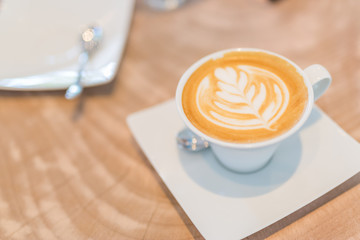 Latte art, coffee on wooden table background