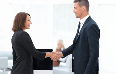 handshake business partners at the negotiating table.