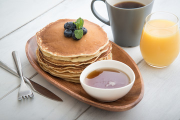 isolated blue berry pancake with  syrup and drink
