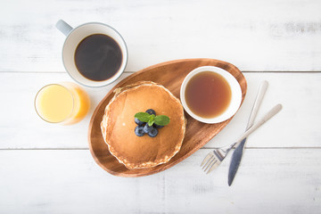 isolated blue berry pancake with  syrup and drink