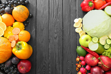 Various fruits and vegetables on wooden background