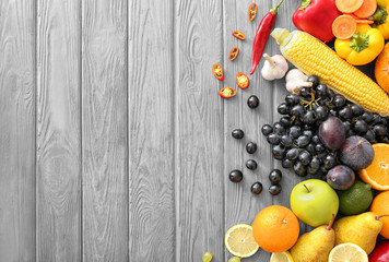 Naklejka na ściany i meble Various fruits and vegetables on wooden background
