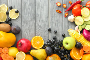 Various fruits and vegetables on wooden background