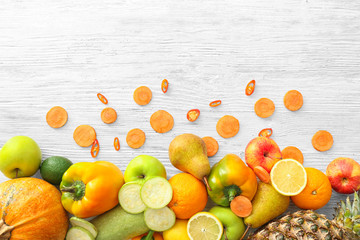 Various fruits and vegetables on wooden background