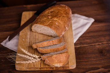 crusty fresh bread on a wood background