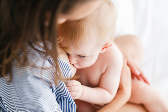 Mother breastfeeding her newborn baby. Close-up shot