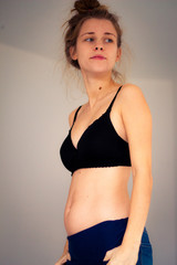Fototapeta premium proud young pregnant woman wearing a bra