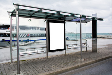 blank advertisement in a bus stop next to the sea and ships in istanbul city