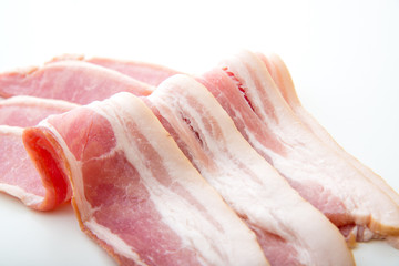 isolated raw bacon on white background