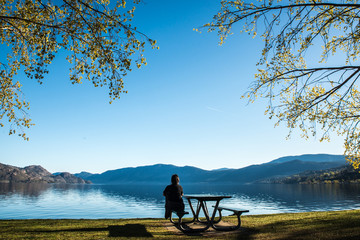 Girl looking at the Okanagan Lake in Peachland British columbia Canada