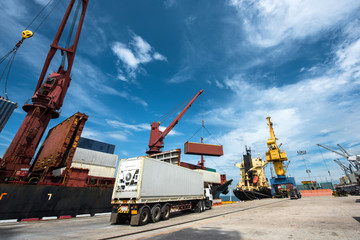 a busy of port congestion by transfering of the shipment delivery with lorry and trailers to the ship in terminal, the logistics system in sea and land transportation services to global worldwide