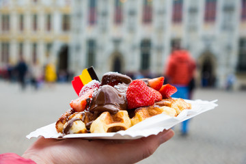 Traditional Belgian dessert - waffle with strawberry and cream. Brugge, Belgium - 182906355
