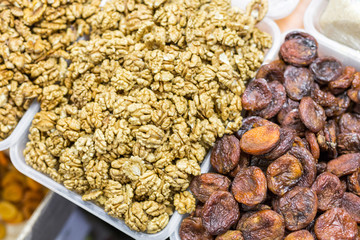 Close-up of fresh tasty peeled   walnut and fried apricots at market