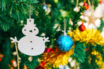 Snowman hung on Christmas tree / Merry Christmas