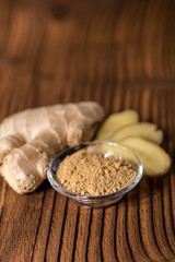close up of a fresh ginger root on an old wood background