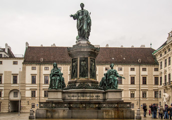 Fototapeta na wymiar Vienna, Austria - december 31, 2013: Hofburg Palace court with people and monument statue of Emperor Francis I, In der burg, Vienna, Austria