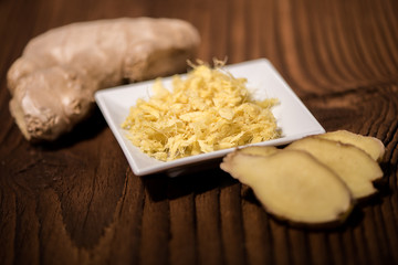 close up of a fresh ginger root on an old wood background