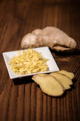 close up of a fresh ginger root on an old wood background
