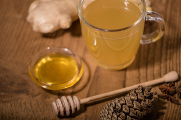 fresh ginger tea with honey on an old wood background