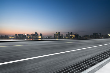 Empty asphalt road through modern city in Hangzhou, China.