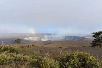 Volcano Crater with glowing fire, steam and rainbow