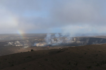 volcanic crater, glowing fire and steam with rainbow