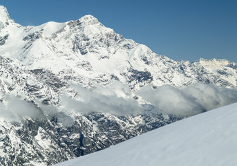 aerial view to mountains valley with snow and clouds in Switzerland