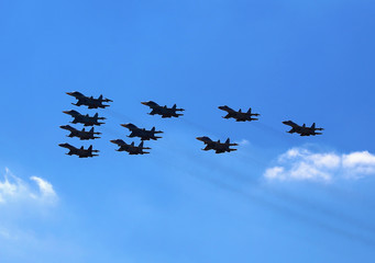 Fototapeta na wymiar Fighters flying in a cloudy sky