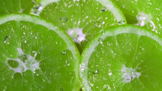 Green Limes Cut with Water Drops Super Slow Motion